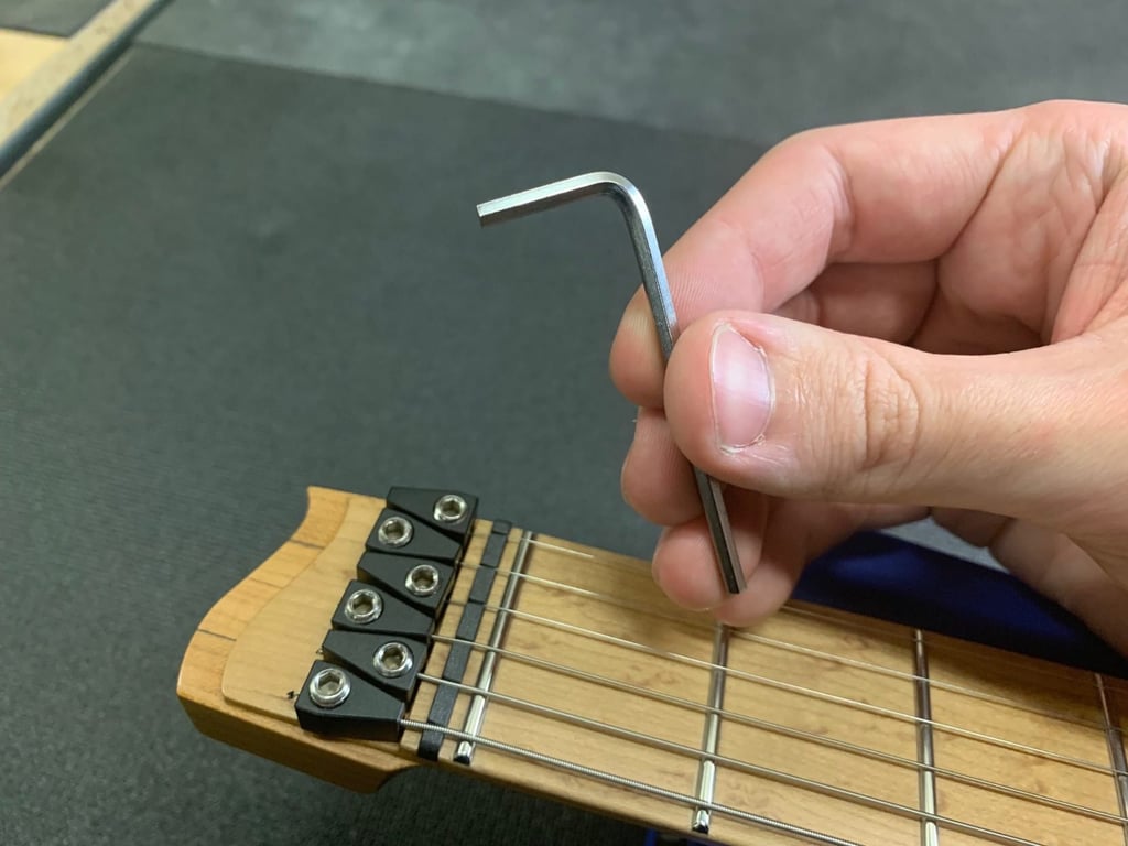 Headless guitar closeup string tuning
