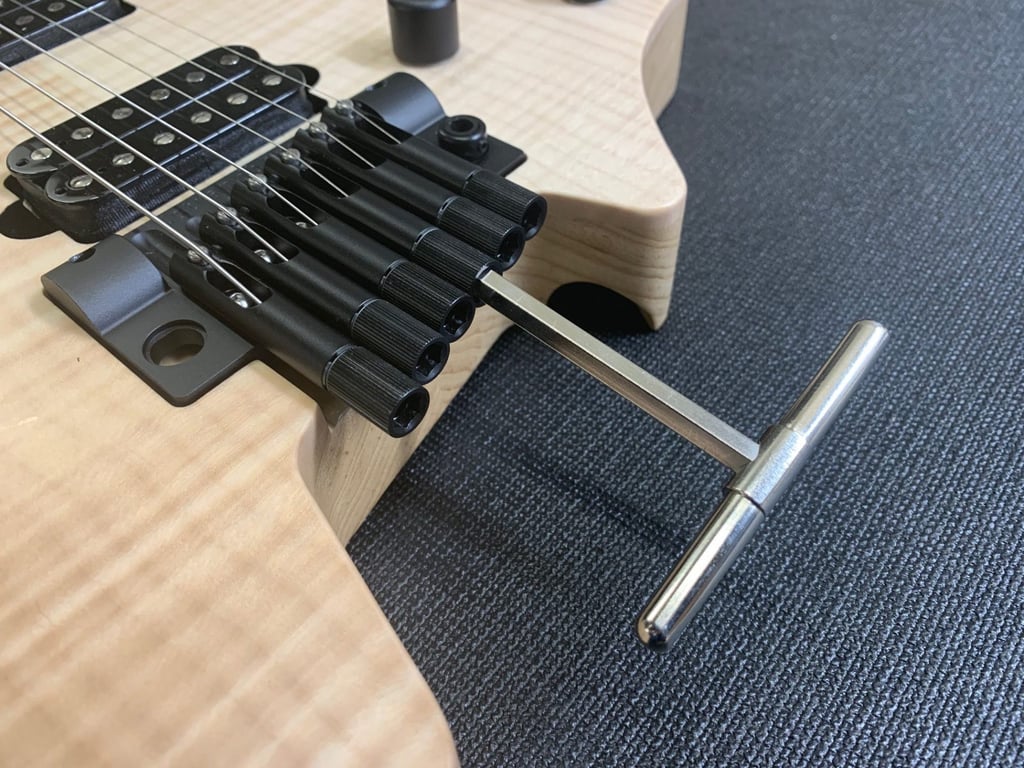 Headless guitar bridge tuning closeup