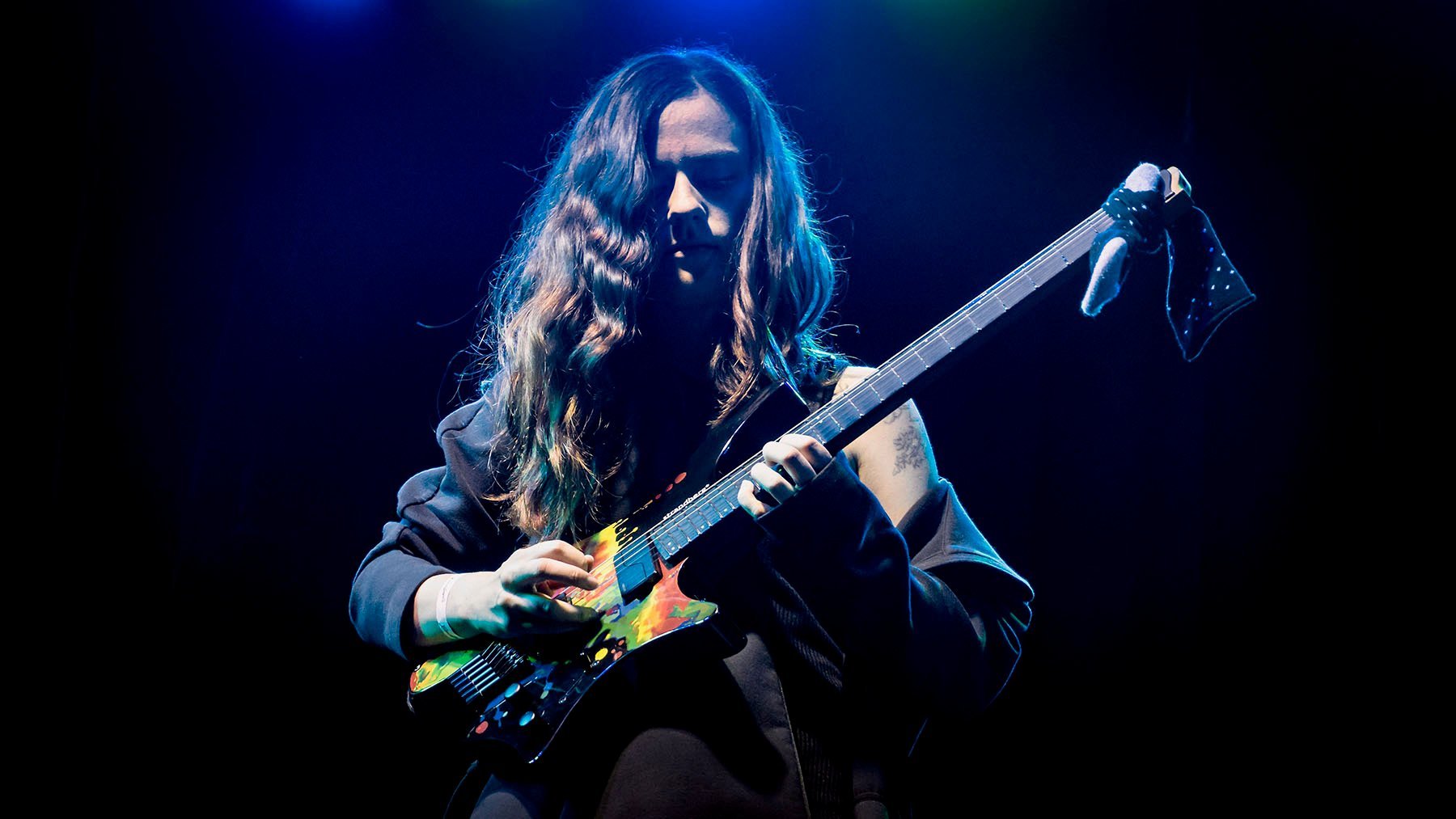 Sara Longfield on stage with her signature headless guitar