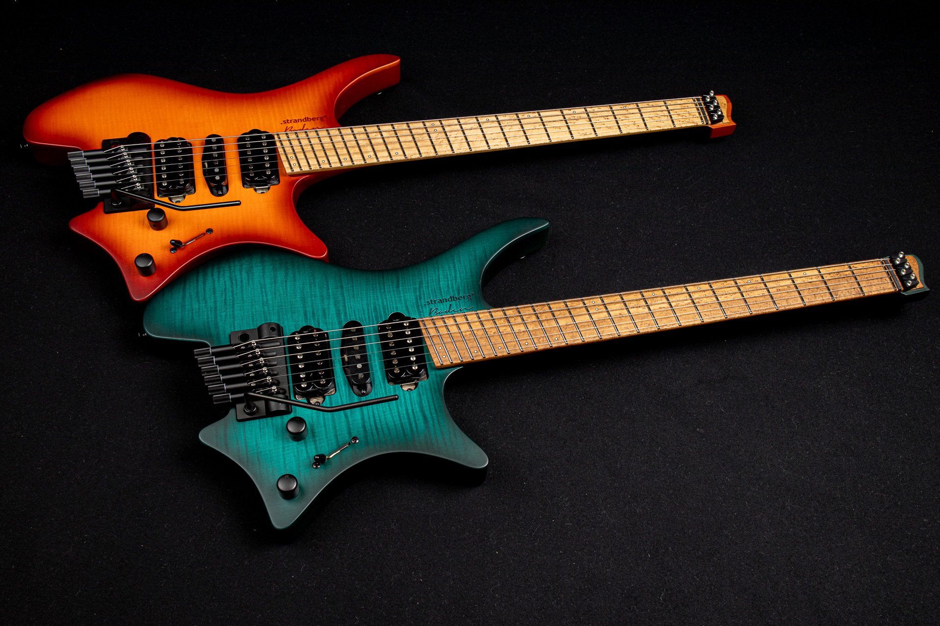 Boden Neck Through headless guitars orange and trans teal side by side