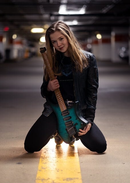 Erin coburn with Strandberg headless NT teal guitar