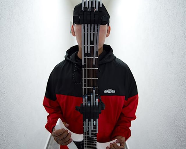 Jose macario holding a strandberg headless guitar