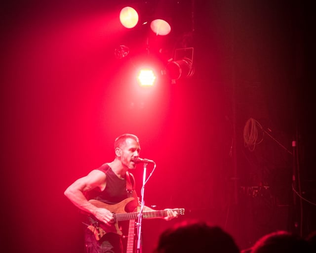 Paul Masvidal on stage with headless strandberg guitar