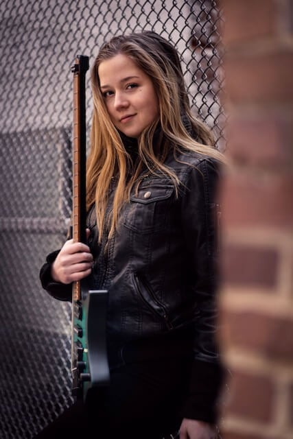 Erin Coburn holding strandberg headless guitar