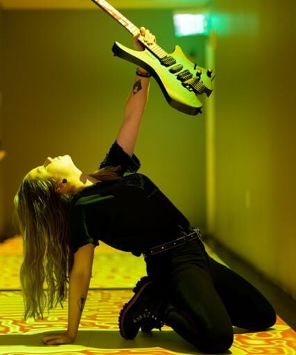 Erin Coburn Holding strandberg headless guitar towards light